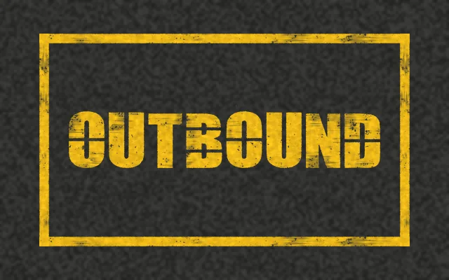 A yellow outlined box on asphalt with OUTBOUND stenciled in yellow